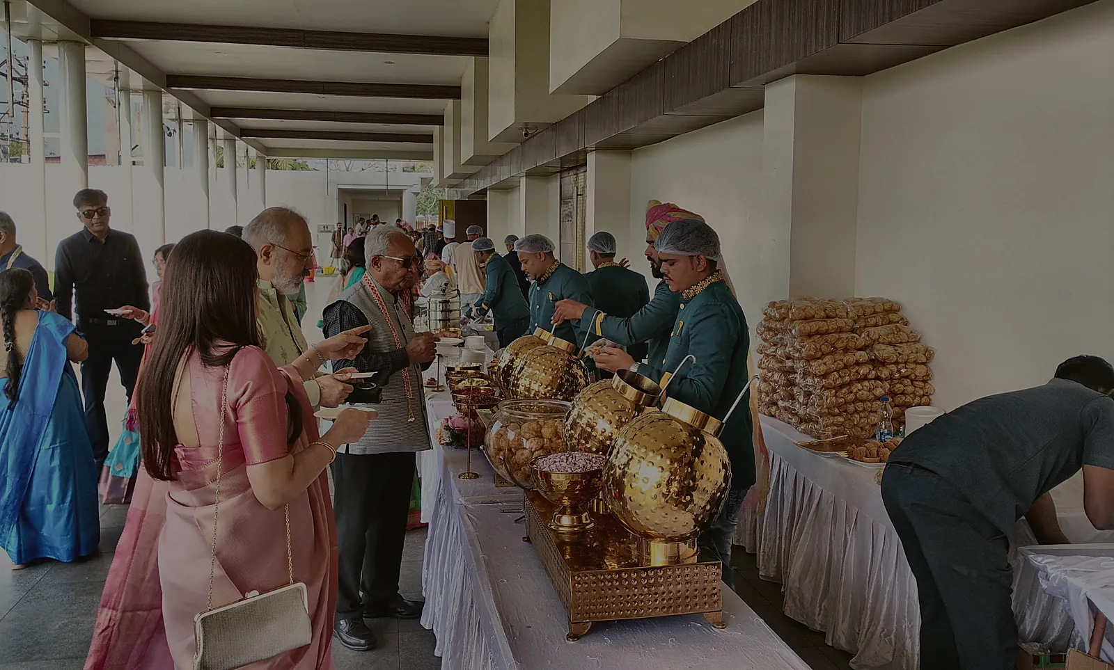 Flavours Tec Kitchen staff in uniform serving guests at an event