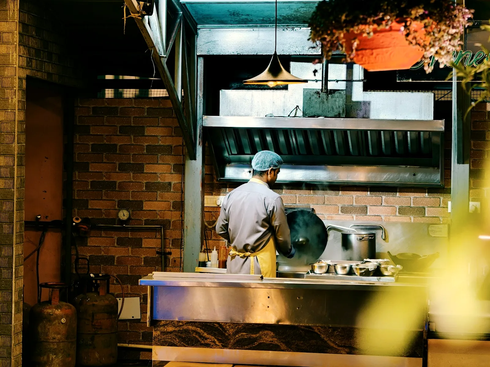 A cook at work in an open counter kitchen